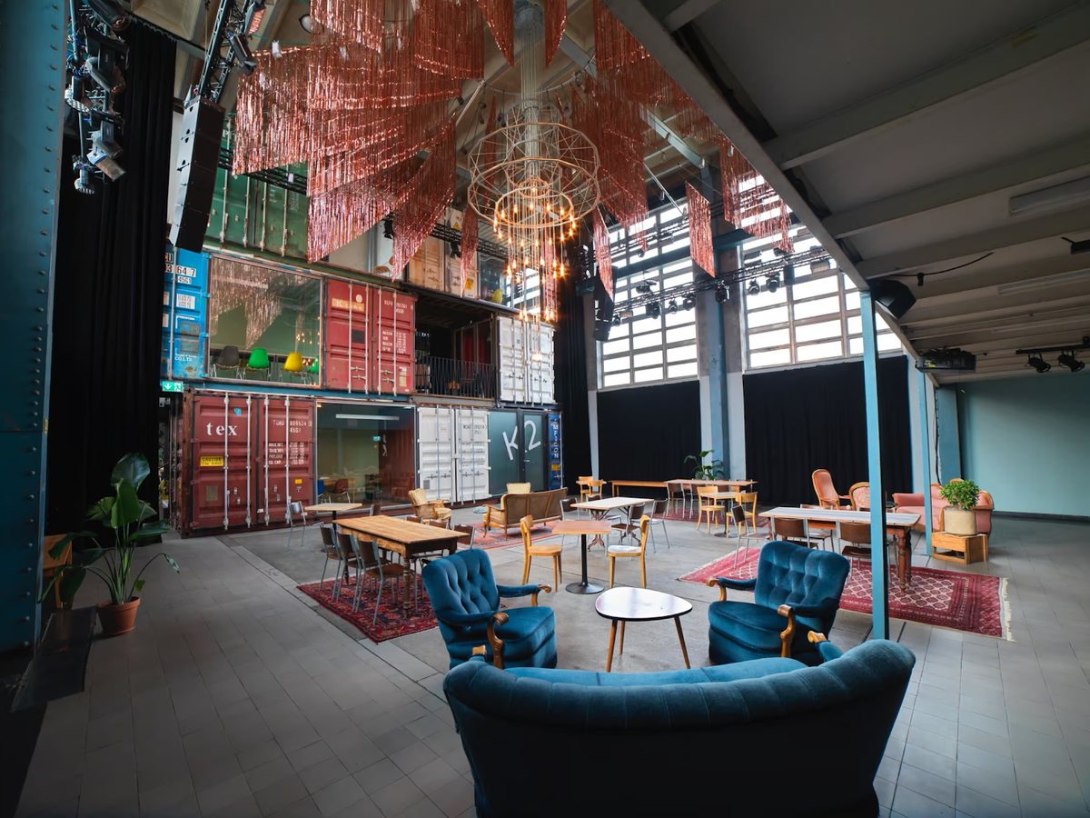 Inside Kraftwerk Zürich: event hall with lounge seating and stacked containers