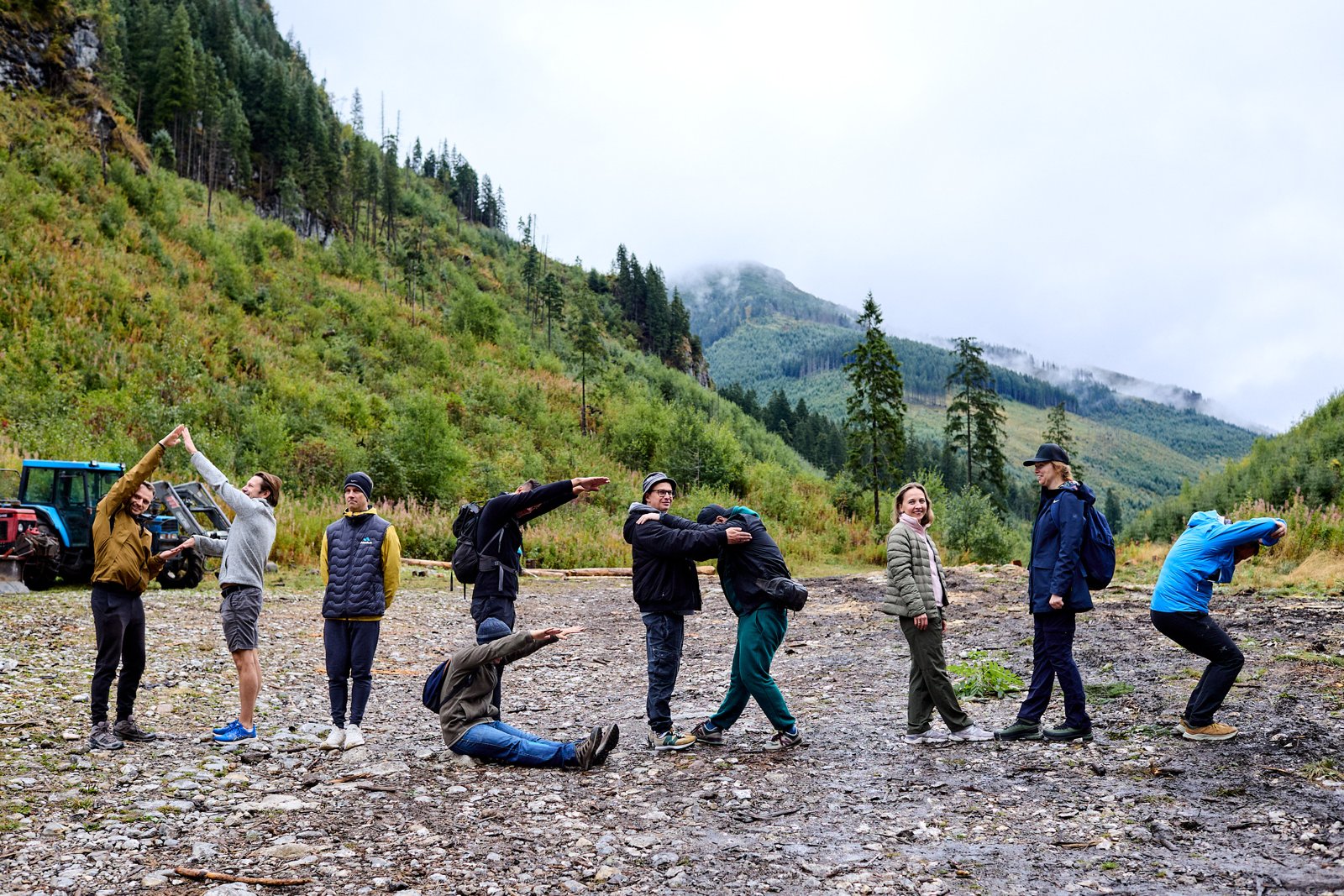 The Aledus team spelling the word Aledus with their bodies in a mountain valley